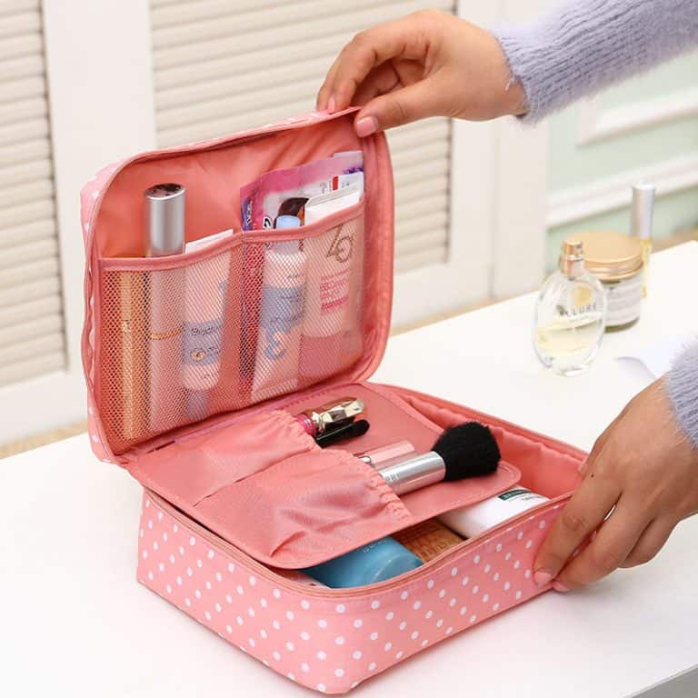 A woman opening a retro-style polka-dot organizer